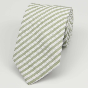 May include: A green and white striped tie. The tie is made of a soft, textured fabric.