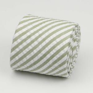 May include: A rolled up green and white striped fabric tie.