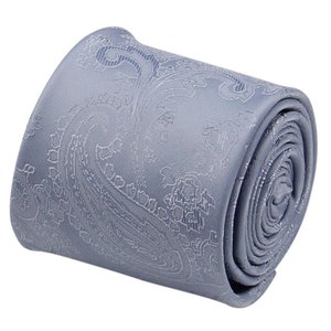 May include: A rolled up light blue paisley patterned tie.