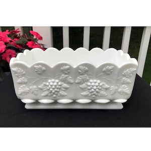 May include: A white milk glass planter with a scalloped rim and embossed grapevine design.