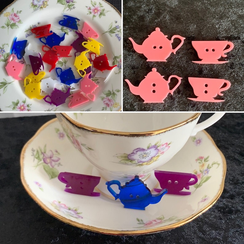 May include: A collection of colorful teapot and teacup buttons. The buttons are made of plastic and are in various colors, including red, blue, yellow, and white. The buttons are arranged on a white plate with a floral pattern.