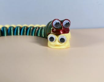 Gusano flexible impreso en 3D: juguete articulado con ojos saltones