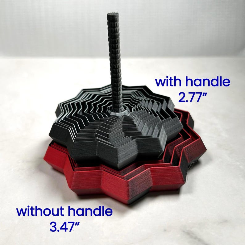 Two 3D printed star fidgets in matte red and black shown stacked together. One version includes a handle (2.77 in high) and one without (3.47 in). Blue text labels each. Displayed on a light marble background.