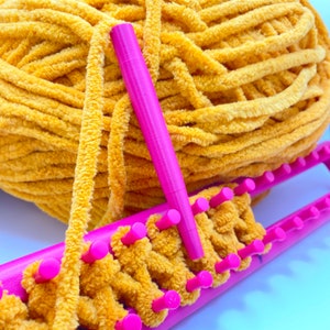 Pink yarn guide shown with standard loom for chunky yarn