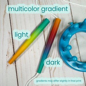 May include: Two tapered knitting needles and a circular blue knitting loom. One needle features a light multicolor gradient from yellow to green, while the other shows a dark gradient from red to blue. Text reads: multicolor gradient, light, dark.