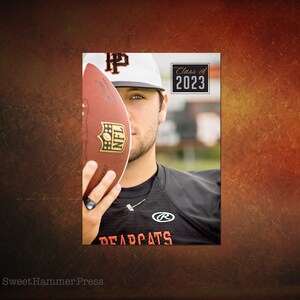 May include: A young man wearing a black jersey with the word "DEADCATS" and a white baseball cap with the letter "HP" on it. He is holding a football in front of his face. The football has the NFL logo on it. The background is a blurred image of a field. The text "Class of 2023" is in a black box with white lettering.