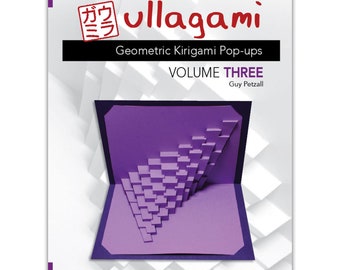 May include: A book cover with the title "ullagami Geometric Kirigami Pop-ups Volume THREE" by Guy Petzall. The cover features a purple pop-up card with a geometric design.