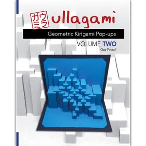 Op de afbeelding: Een boekomslag met de titel "ullagami Geometric Kirigami Pop-ups VOLUME TWO" door Guy Petzall. De omslag toont een blauwe pop-up van een stadsbeeld.