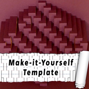 Op de afbeelding: Een bordeauxrode papieren pop-upkaart met een 3D geometrisch ontwerp. De kaart is gedeeltelijk open, waardoor een witte papieren sjabloon zichtbaar wordt met de tekst "Make-it-Yourself Template".