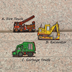 May include: Three embroidered patches depicting different vehicles: a red fire engine with a ladder, a yellow excavator, and a green refuse truck. The patches are labelled A. Fire Truck, B. Excavator, and C. Garbage Truck.