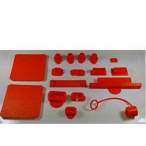 May include: A set of 18 orange plastic 3D printed parts, including two square plates, a long rectangular piece, a shorter rectangular piece, a ring, a curved piece, and several small round pieces.