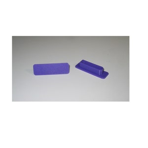May include: Two purple plastic end caps for a rectangular object. One end cap is flat and the other has a raised lip.