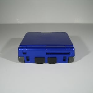 2 piece set of Game boy advance SP power and link port covers Made in the USA.