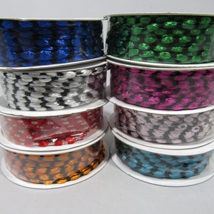 May include: Six spools of black and white patterned ribbon in various colours, including blue, green, pink, red, orange, and teal.