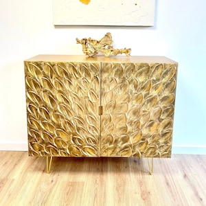 Gold cabinet with leafy texture and gold hairpin legs