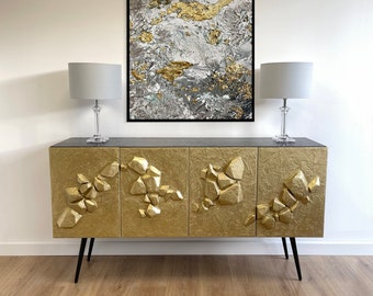 Gold cabinet. Contemporary style sideboard with gold 3D cut stone design