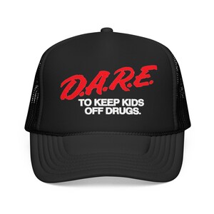 May include: Black trucker hat with a curved brim and mesh back. The front of the hat features the red text "D.A.R.E." above the words "TO KEEP KIDS OFF DRUGS."