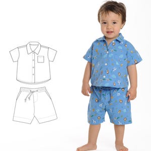 May include: A blue and white patterned short-sleeved shirt and matching shorts set for a child. The shirt has a button-up front and a pocket on the left chest. The shorts have an elastic waistband with a drawstring.