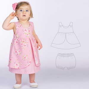 May include: A pink sleeveless dress with a floral print and a matching pair of bloomers. The dress has a gathered skirt and a round neckline. The bloomers have an elastic waistband.