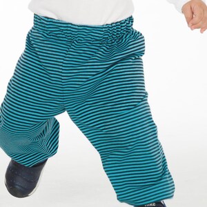 Child wearing handmade elastic waist pants in colorful fabric