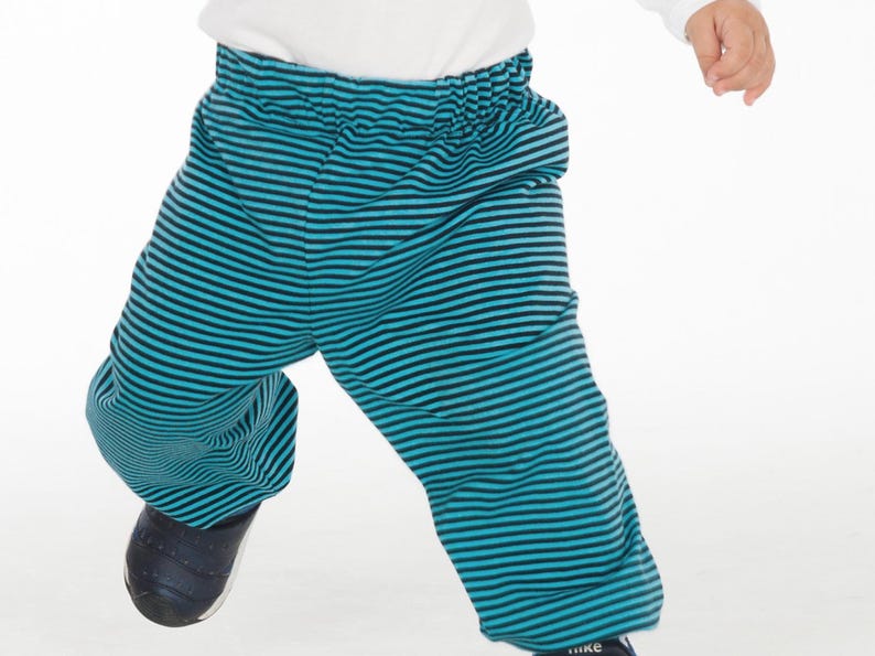 Child wearing handmade elastic waist pants in colorful fabric