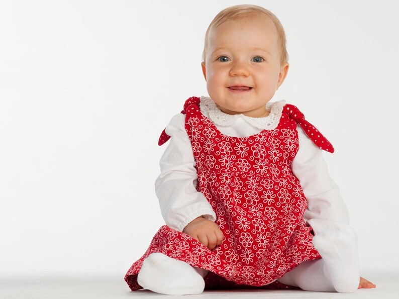 Glückliches Baby sitzt, rotes Blumenkleid über Body, einfaches babykleid nähen, anfängerfreundlich