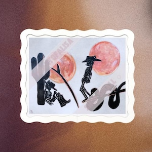 May include: Two black silhouette skeletons wearing cowboy hats, one riding a snake and the other sitting on a cactus, against a background of two pink and orange moons.