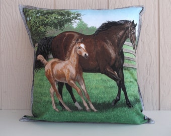 May include: A brown and white horse and a brown foal run through a green field. The horse and foal are in the foreground of the image, with a green field and a wooden fence in the background.