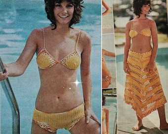 May include: A yellow and white crochet bikini set with a matching crochet skirt. The bikini top has a triangle shape and the bottoms are high-waisted. The skirt is long and flowing with a fringe hem.