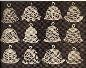 May include: Twelve crocheted white bell ornaments with a delicate lace pattern. The bells are arranged in four rows of three.
