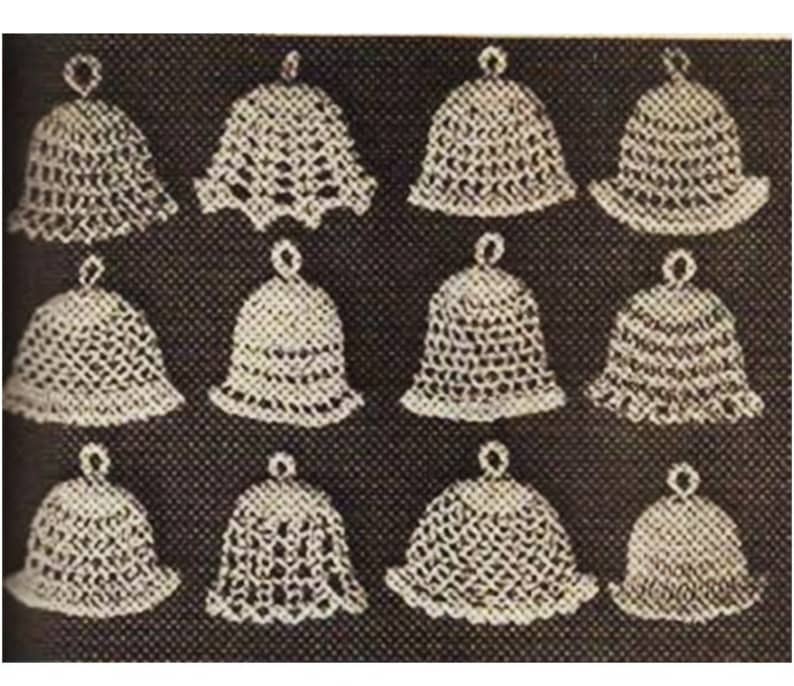 May include: Twelve crocheted white bell ornaments with a delicate lace pattern. The bells are arranged in four rows of three.