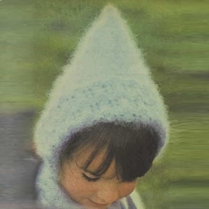 May include: A light blue knitted hat with a pointed top and a long scarf. The hat is made of a soft, fuzzy yarn.