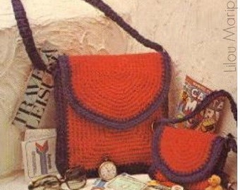 May include: Two crocheted bags, one red and one smaller red, with a purple trim. The bags have a rounded flap and a strap. The bags are sitting on a table with other items.