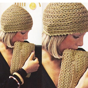 May include: A woman is wearing a gold crocheted hat and holding a gold crocheted clutch purse.