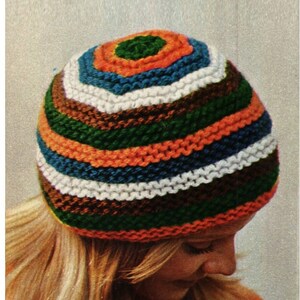 May include: A striped knit hat with a colorful pattern of orange, green, blue, white, and brown. The hat is made with a simple knit stitch and has a rounded crown.