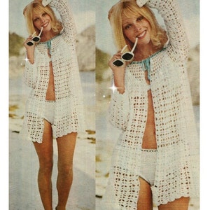 May include: A white crochet beach cover-up with long sleeves and a tie at the neck. The cover-up is open at the front and has a crocheted pattern.