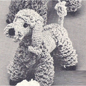 May include: A white crocheted poodle dog toy. The poodle has a curly, fluffy texture and a long tail.