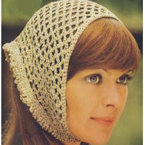 May include: A close-up of a woman wearing a crocheted head scarf. The scarf is a light beige color and has a delicate openwork pattern. The woman has long, brown hair and is wearing a light-colored top.
