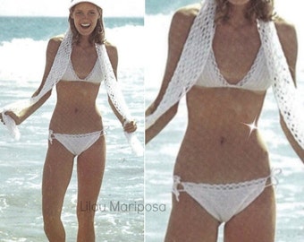May include: A woman wearing a white crochet bikini top and matching bikini bottoms. She is standing on a beach with the ocean in the background. The text "Lilou Mariposa" is visible in the lower right corner of the image.
