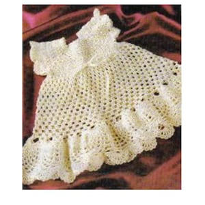 May include: A white crocheted baby dress with a ruffled hem and a scalloped neckline.
