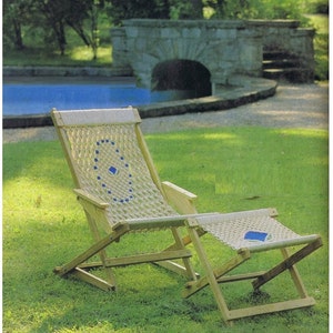 May include: A wooden folding chair and footrest with a woven rope seat and back. The chair and footrest are both in a natural wood finish and have a blue and white geometric pattern woven into the rope.