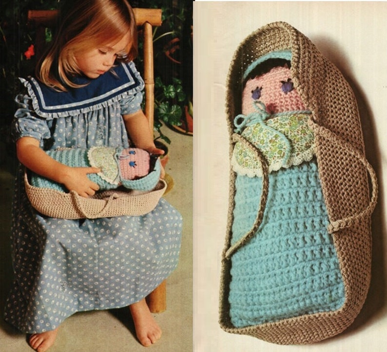 May include: A crocheted baby doll in a brown crocheted bassinet. The doll is wearing a blue and white crocheted dress and a floral print bonnet. The bassinet has a handle on each side.