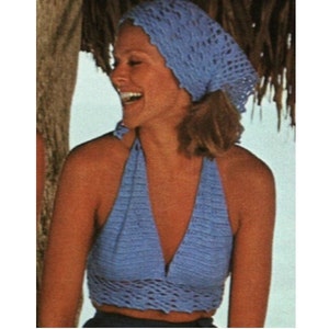 May include: A blue crocheted halter top with a matching blue crocheted head scarf. The top has a deep V-neckline and a wide, open back.