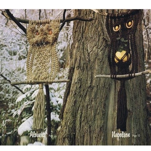 May include: Two macrame owl wall hangings, one brown and one beige, hanging from branches in a snowy forest. The brown owl has a small gourd hanging from its belly. The beige owl has a tassel hanging from its bottom. The text "A louette Page 11" is below the beige owl and "Napoleon Page 12" is below the brown owl.