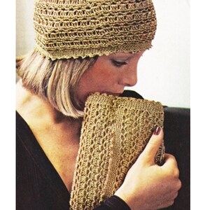 May include: A woman wearing a gold crocheted hat and holding a matching gold crocheted clutch.