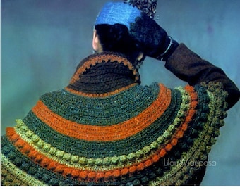May include: A brown, green, orange, and beige crocheted shawl with a scalloped edge and a textured bobble stitch. The shawl is worn by a person with a blue hat and brown coat.