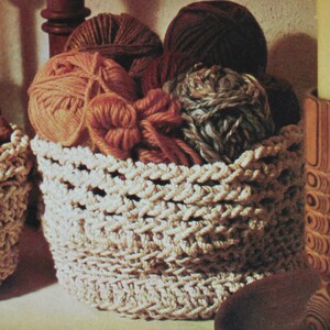 May include: A white crocheted basket filled with colorful yarn balls. The basket has a woven pattern and is a great storage solution for craft supplies.