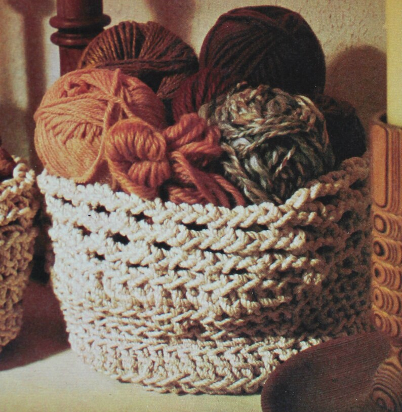 May include: A white crocheted basket filled with colorful yarn balls. The basket has a woven pattern and is a great storage solution for craft supplies.