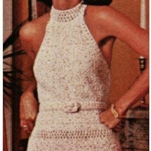 May include: A white crocheted halter top with a high neckline and a belt at the waist.