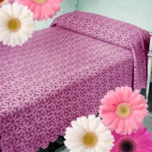 May include: A pink crocheted bedspread with a floral pattern. The bedspread has a scalloped edge and is made of a delicate, lightweight material.